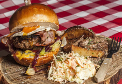 Un gros repas, cheeseburger très garni avec patates et salade de choux